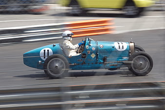 Vintage Blue Racing Car With Number 11 On Track