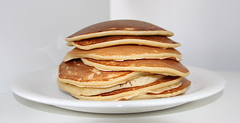 Stack of Golden Brown Pancakes on White Plate