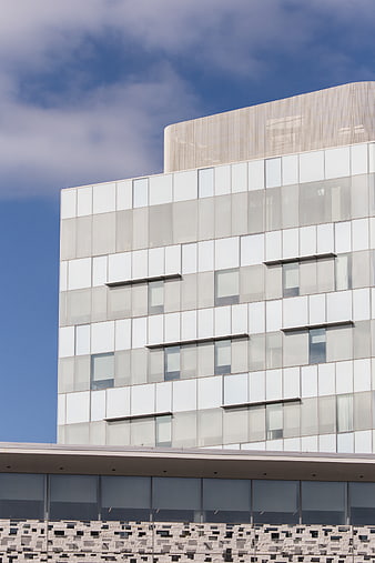 Modern white office building facade with blue sky
