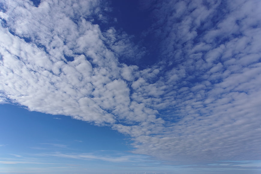 Blue sky with scattered altocumulus clouds