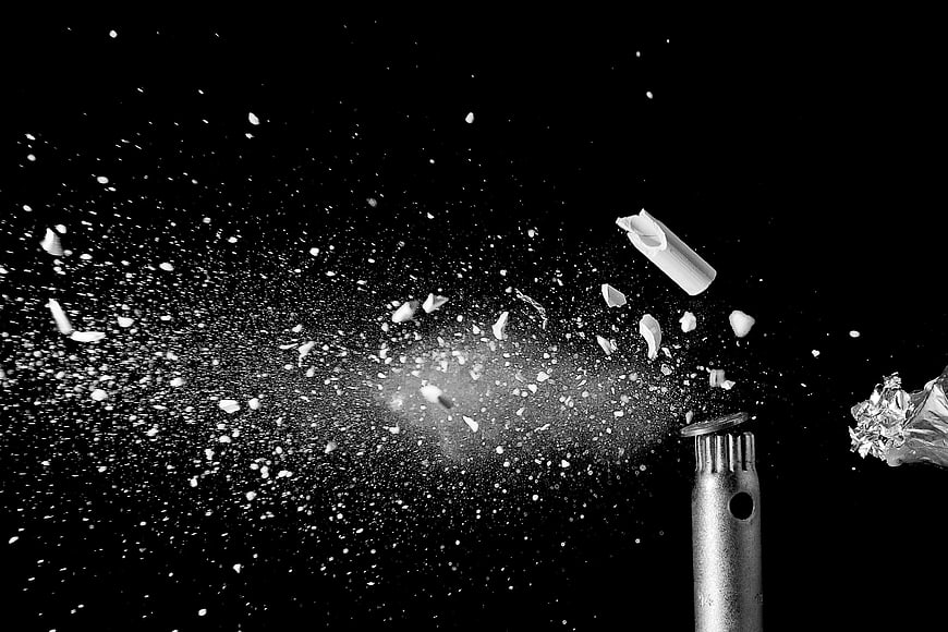 High-speed black and white photo of bullet shattering ceramic