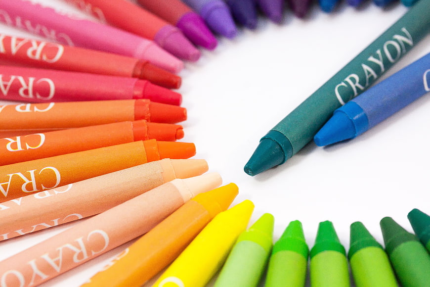 Colorful Crayons Arranged in a Circle on White Background