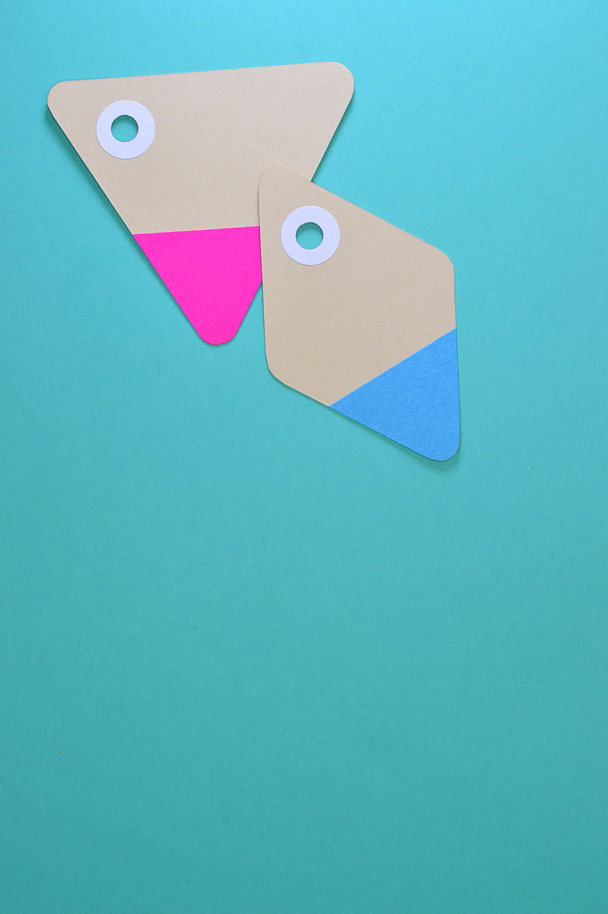 Colorful Geometric Paper Tags on Teal Background