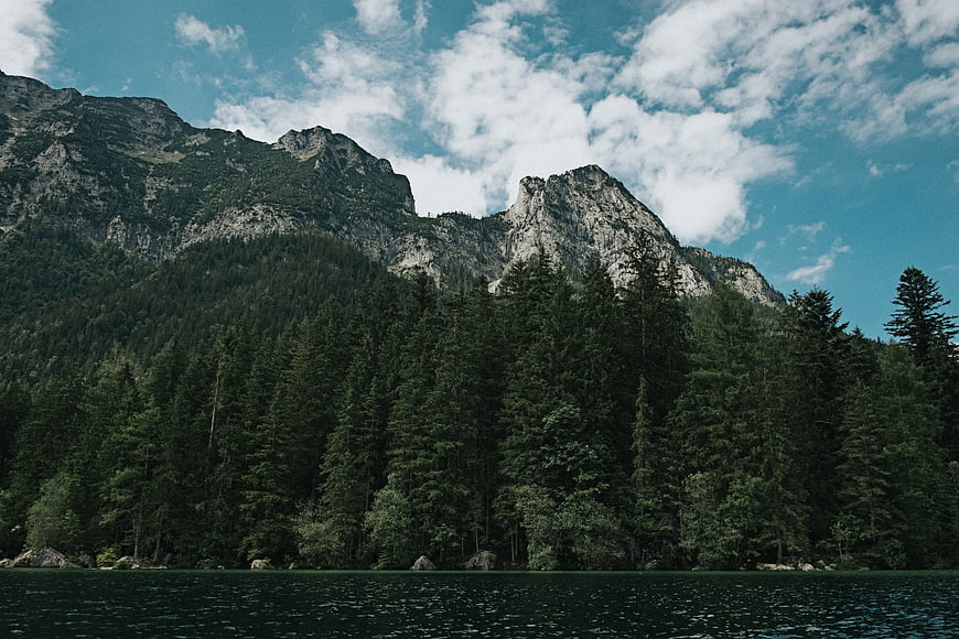Serene Alpine Lake with Forest and Mountain Peaks