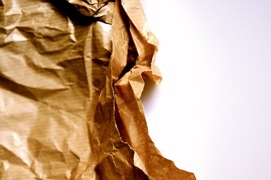 Crumpled brown paper texture background with white space