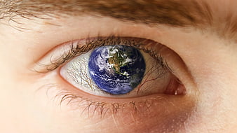 Close-up of human eye with Earth reflection in iris