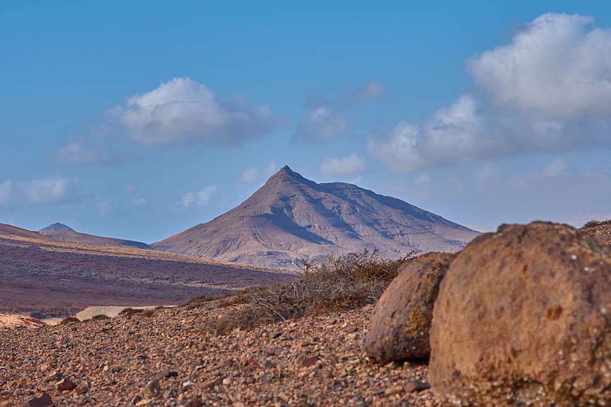Volcanic Landscape with Rocky Foreground and Blue Sky