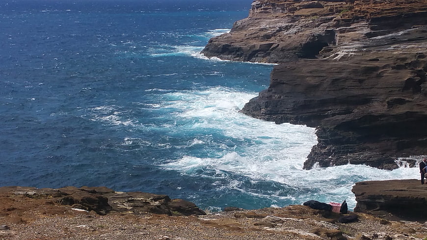 Dramatic ocean waves crashing against rugged coastal cliffs