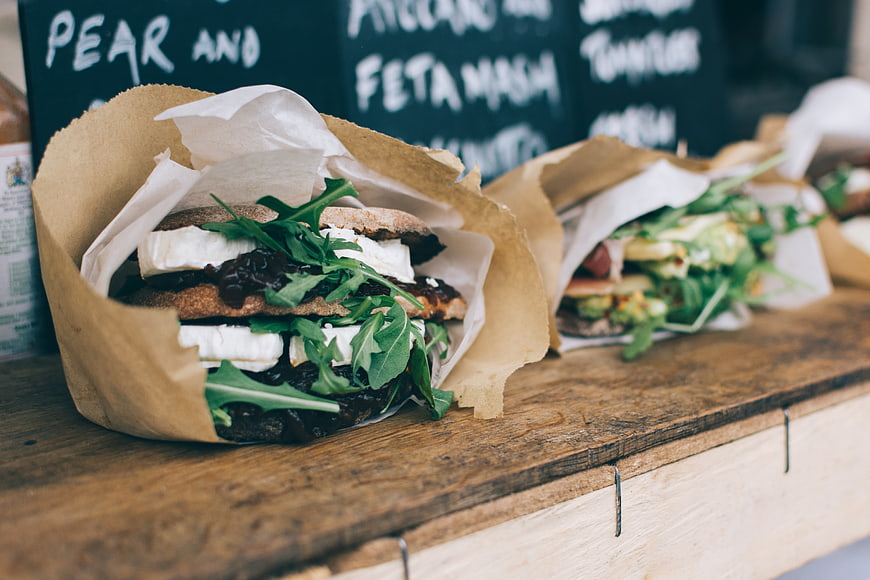 Fresh artisanal pear and feta sandwich on wooden counter