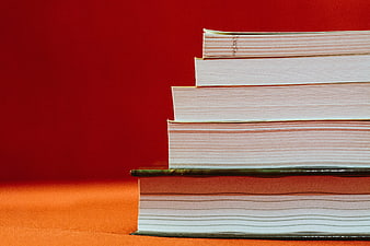 Stack of Books on Red Background with Copyspace