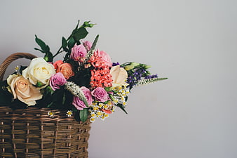 Colorful Floral Arrangement in Wicker Basket with Copyspace