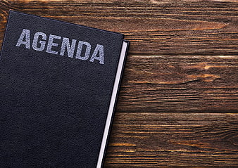 Black Agenda Notebook on Wooden Table with Copyspace