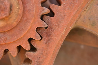 Close-up of rusted metal gears showing industrial corrosion and mechanical texture