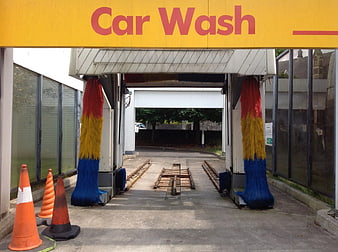 Empty Car Wash Tunnel with Colorful Brushes and Sign
