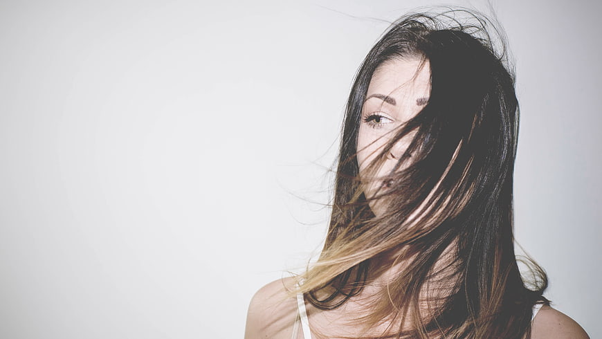 Woman with Windblown Hair Portrait on White Background