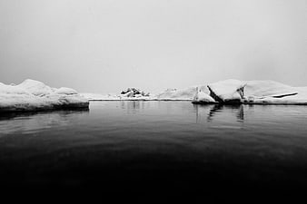 Minimalist Black and White Icebergs in Calm Water