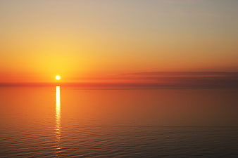 Serene Sunset Over Calm Ocean Water