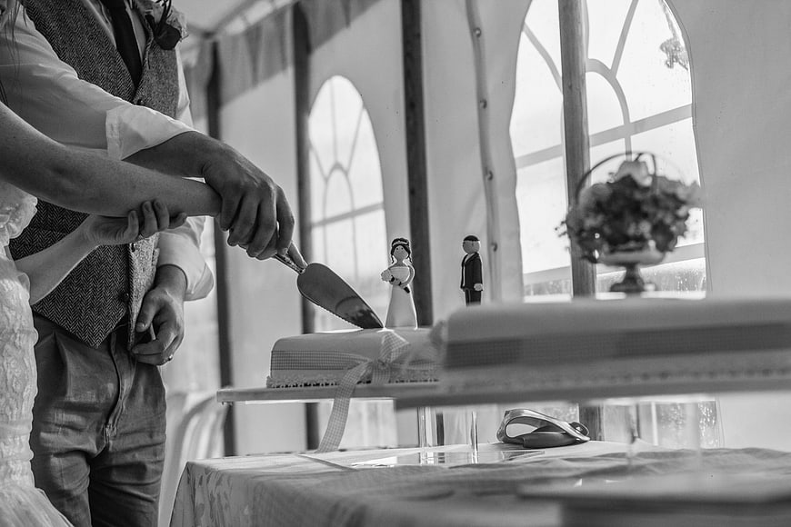 Bride and Groom Cutting Wedding Cake in Black and White