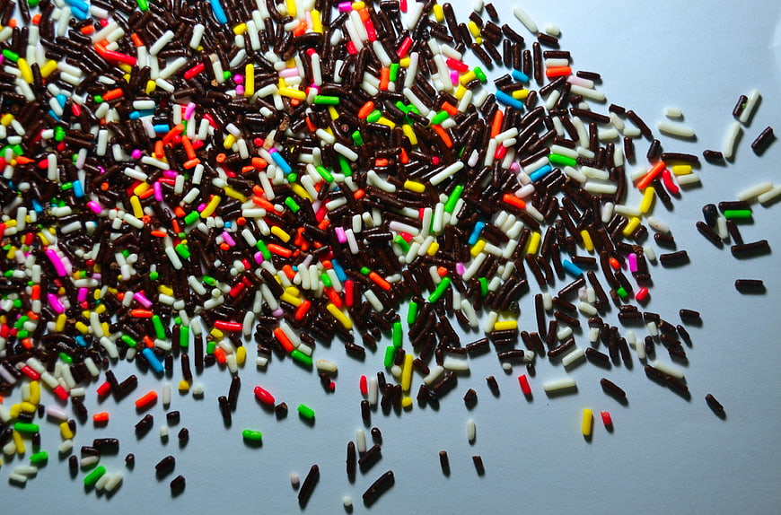 Colorful Sprinkles Scattered On White Surface