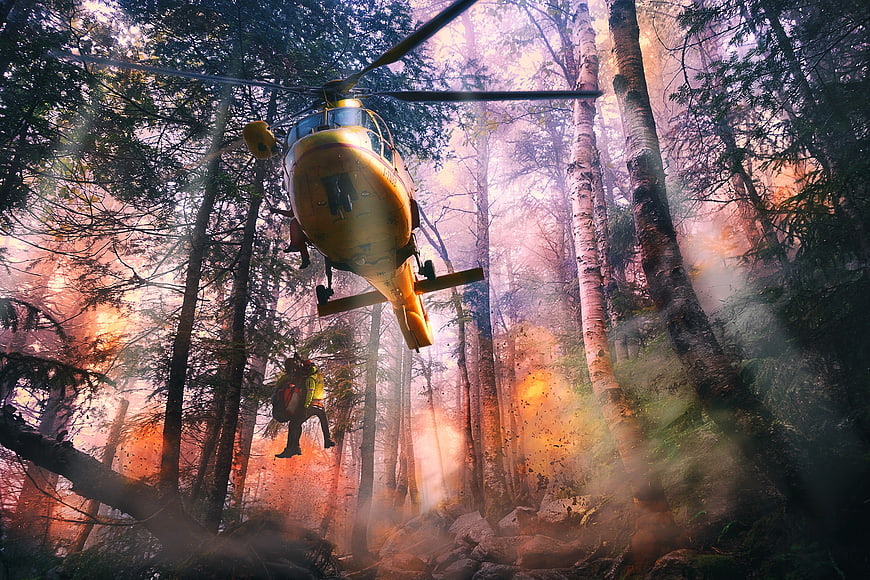 Yellow Helicopter Rescue Operation in Smoky Forest
