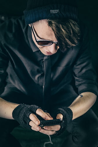 Man in Beanie and Fingerless Gloves Using Smartphone