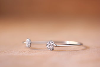 Silver Gemstone Bangle Bracelets on Wooden Surface