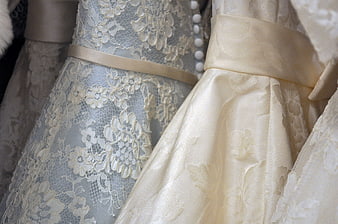 Close-up of elegant lace and satin wedding dresses