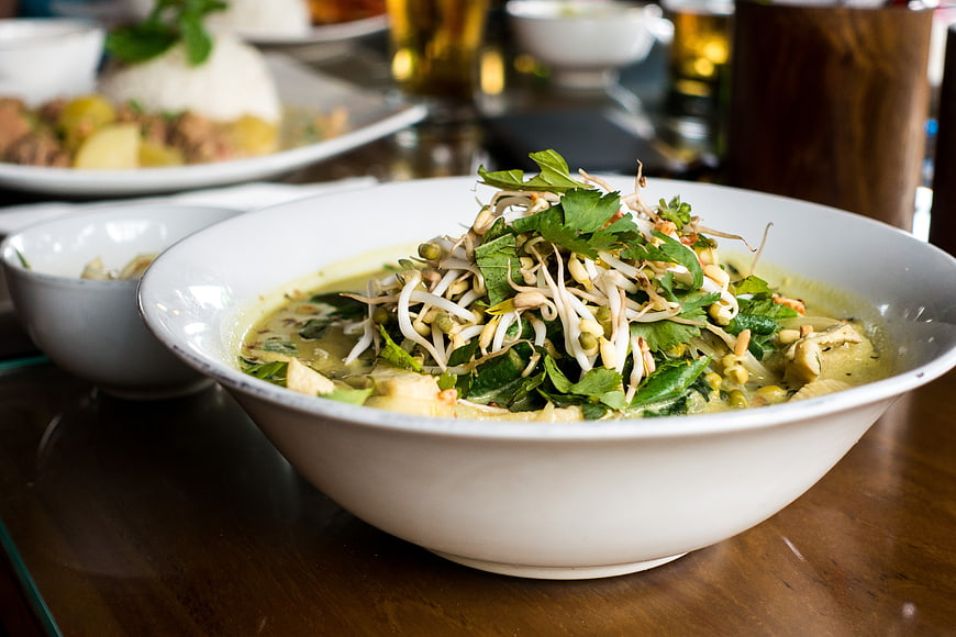 Bowl of Thai Green Curry with Bean Sprouts and Herbs