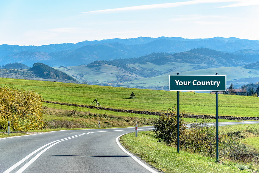 Rural Road With Your Country Sign And Green Mountain Landscape