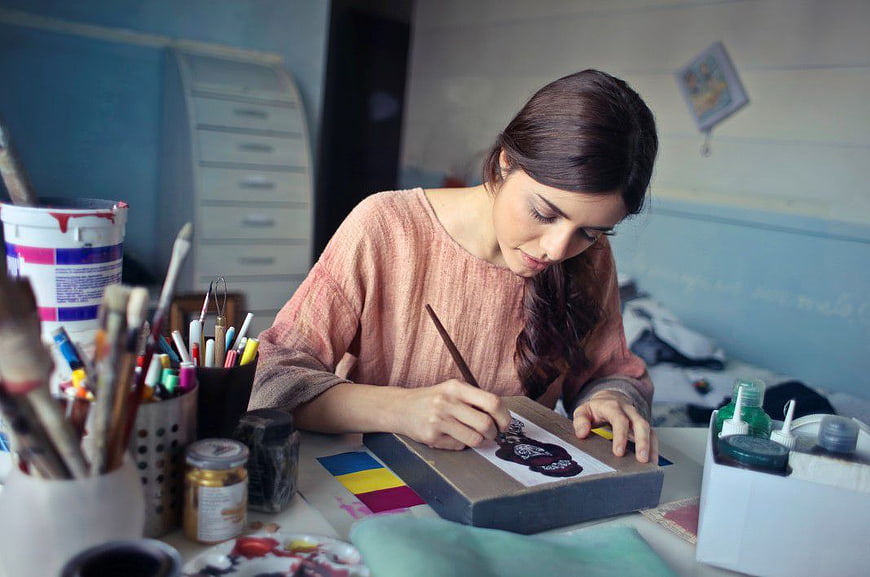 Woman artist painting in creative studio workspace