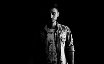 Dramatic black and white portrait of a young man in denim