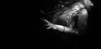 Underwater black and white photo of woman swimming