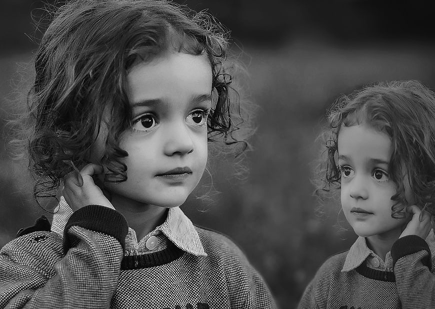 Black and white portrait of two young girls with curly hair
