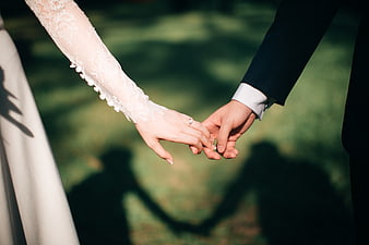 Bride and Groom Holding Hands with Wedding Ring