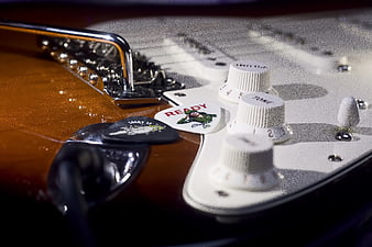 Close-up of Electric Guitar Controls and Picks