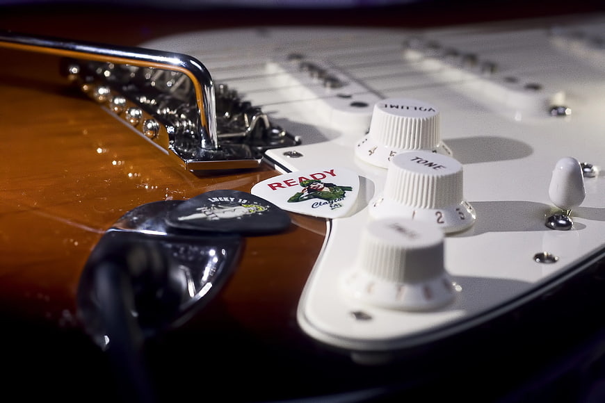 Close-up of Electric Guitar Controls and Picks