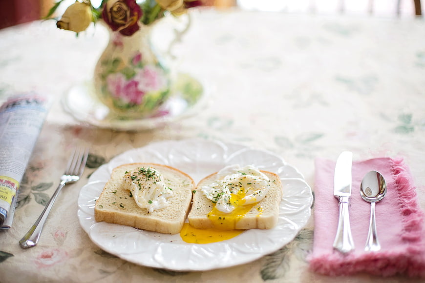 Poached Eggs on Toast with Runny Yolk and Vintage Table Setting