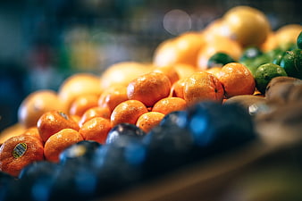 Fresh Oranges And Limes At A Market Stall