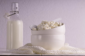 Cottage Cheese Bowl With Milk Bottle On White Table