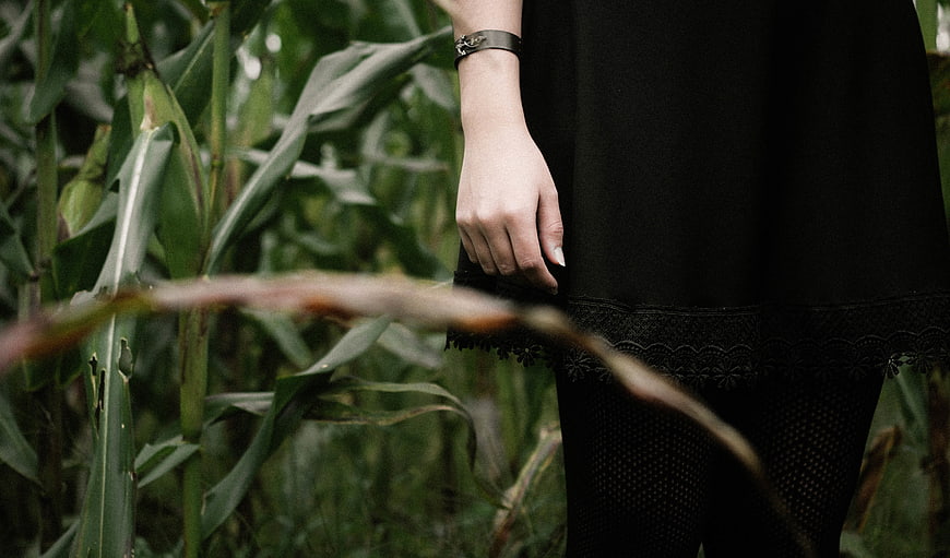 Woman in Black Dress Standing in Cornfield