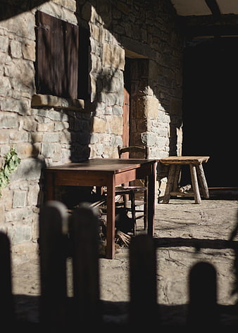 Rustic Stone Patio with Wooden Table and Stool