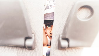 Child peeking through car seat gap with magazine