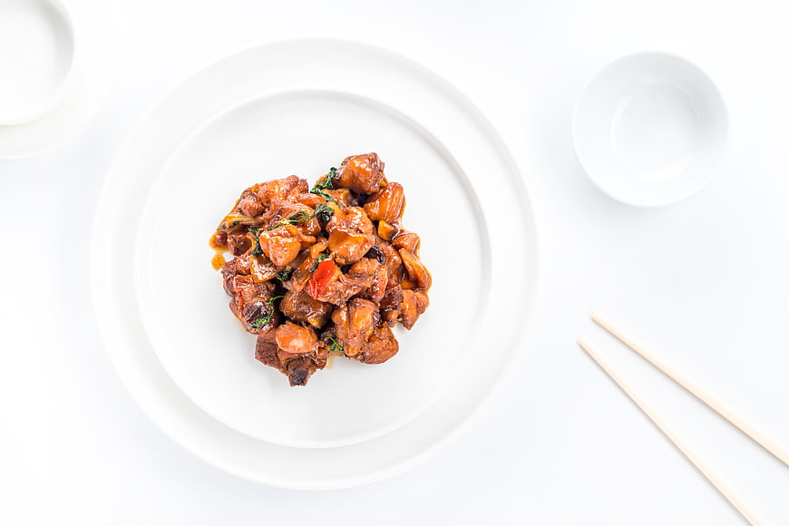 Top View of Stewed Chicken with Three Cups Sauce on White Plate