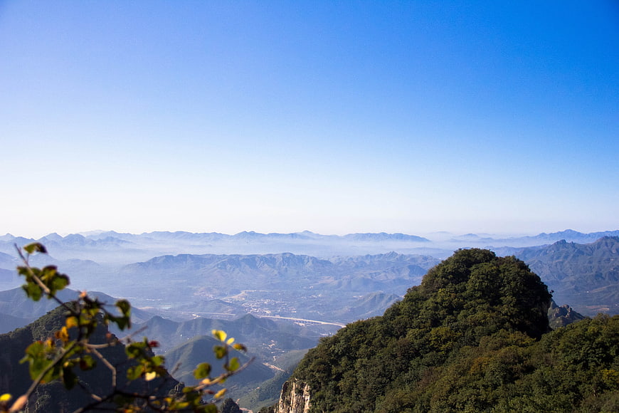 Panoramic view of Wolf Teeth Mountain with blue sky and forest