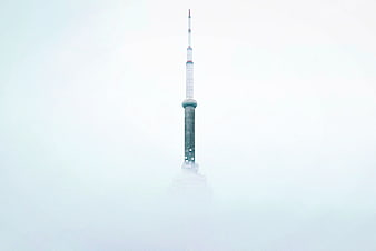 CN Tower Spire Emerging from Thick White Fog
