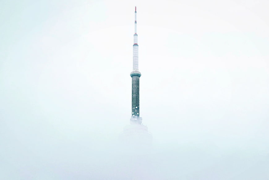 CN Tower Spire Emerging from Thick White Fog