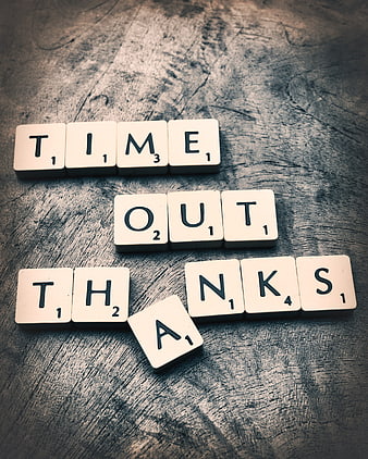 Scrabble tiles spelling Time Out Thanks on rustic wooden surface
