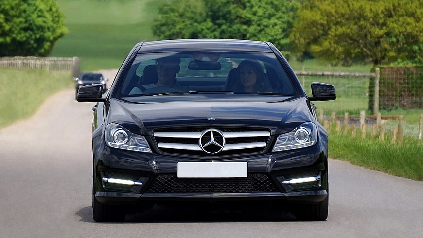 Black Mercedes-Benz C-Class Driving on Country Road