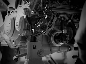 Close-up of Nissin brake caliper on motorcycle engine