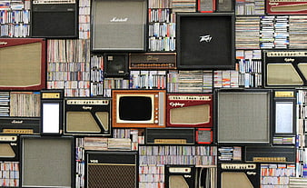 Wall of vintage guitar amplifiers and CD collection